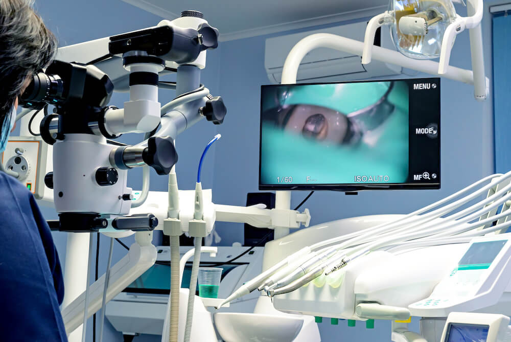 endodontist working on patient with dental microscope, Endodontist Accepts Insurance in Bethelehem PA